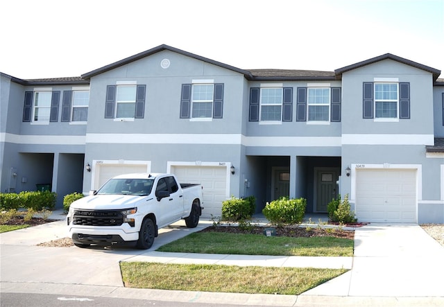 36439 Garden Wall Way, Zephyrhills, FL 33541 - view of property with a garage, stucco siding, and driveway