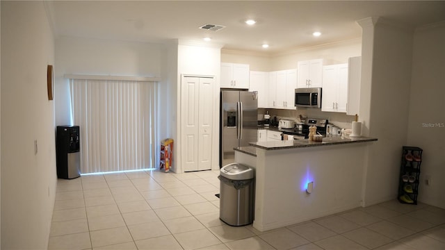 36439 Garden Wall Way, Zephyrhills, FL 33541 - kitchen with appliances with stainless steel finishes, a peninsula, white cabinetry, light tile patterned flooring, and recessed lighting