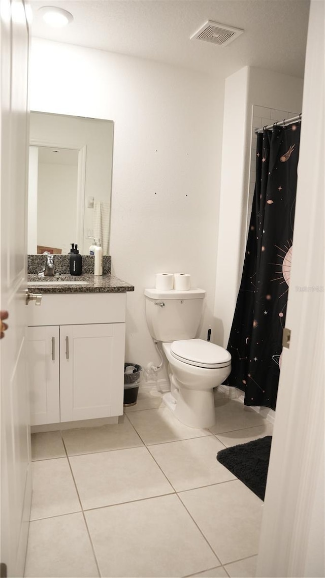 36439 Garden Wall Way, Zephyrhills, FL 33541 - bathroom featuring vanity, tile patterned floors, toilet, and a shower with shower curtain