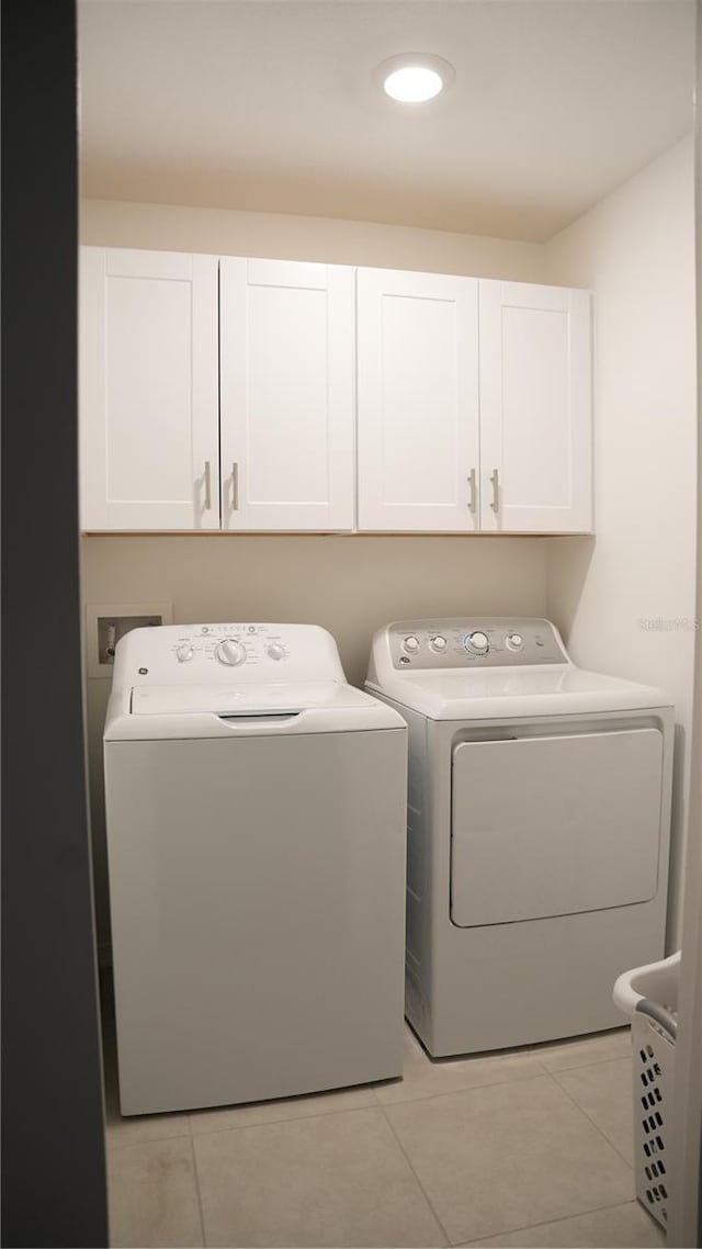 36439 Garden Wall Way, Zephyrhills, FL 33541 - washroom featuring cabinet space, washer and clothes dryer, light tile patterned floors, and recessed lighting