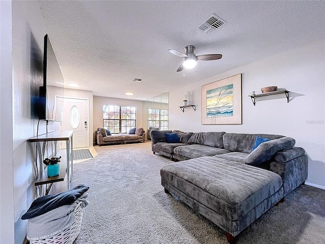 2031 Dover Ct, Oldsmar, FL 34677 - carpeted living room featuring a textured ceiling, a ceiling fan, and baseboards