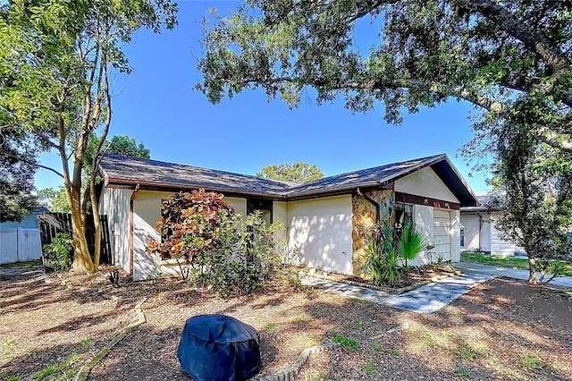 2031 Dover Ct, Oldsmar, FL 34677 - view of side of home with an attached garage and stucco siding