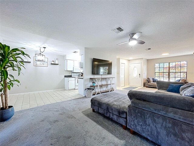 2031 Dover Ct, Oldsmar, FL 34677 - living room with light tile patterned flooring, a textured ceiling, light carpet, ceiling fan, and baseboards
