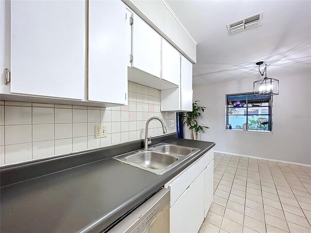 2031 Dover Ct, Oldsmar, FL 34677 - kitchen with a sink, dark countertops, white cabinets, and baseboards