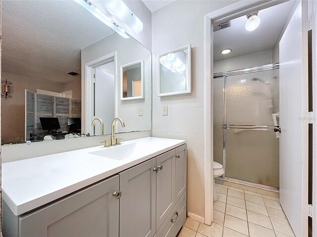 2031 Dover Ct, Oldsmar, FL 34677 - full bathroom with tile patterned floors, vanity, toilet, a stall shower, and a textured ceiling