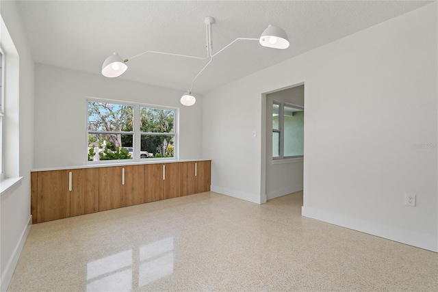 433 Pineapple St, Tarpon Springs, FL 34689 - empty room featuring baseboards and speckled floor