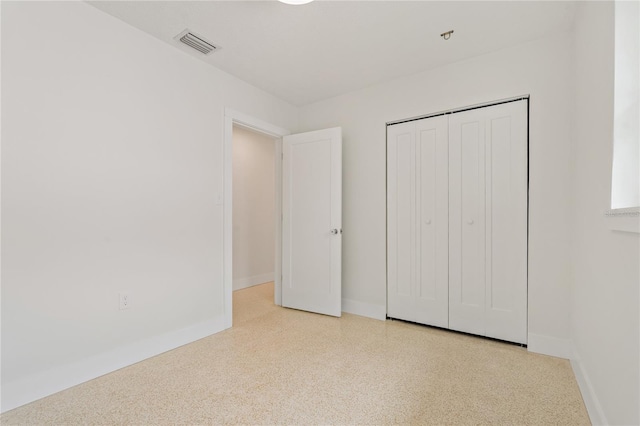 433 Pineapple St, Tarpon Springs, FL 34689 - unfurnished bedroom featuring baseboards, speckled floor, and a closet