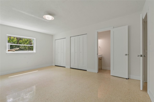 433 Pineapple St, Tarpon Springs, FL 34689 - unfurnished bedroom featuring two closets and baseboards