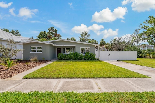 433 Pineapple St, Tarpon Springs, FL 34689 - view of front facade featuring a gate, driveway, and stucco siding