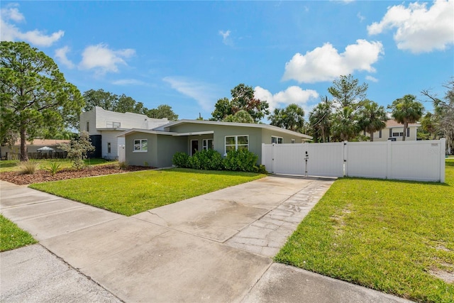 433 Pineapple St, Tarpon Springs, FL 34689 - view of front of property with a gate, concrete driveway, and stucco siding