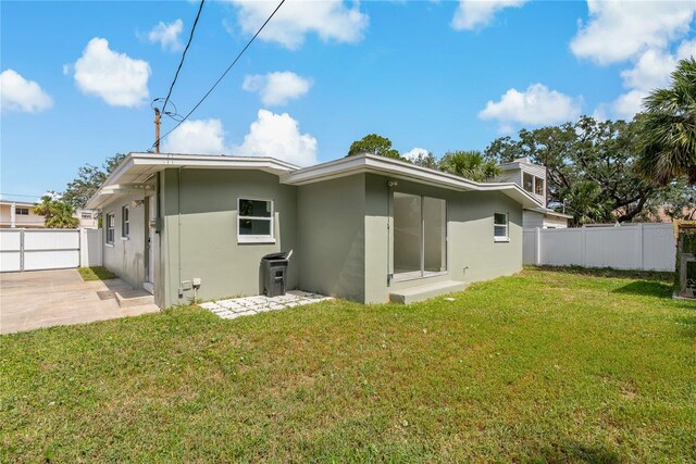 433 Pineapple St, Tarpon Springs, FL 34689 - back of house featuring stucco siding and a patio area