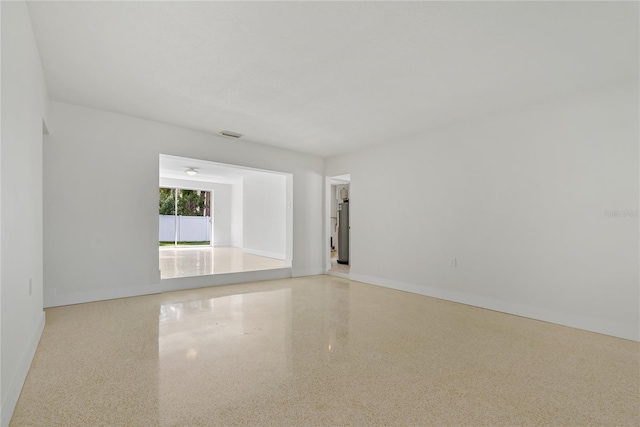 433 Pineapple St, Tarpon Springs, FL 34689 - empty room with speckled floor and baseboards