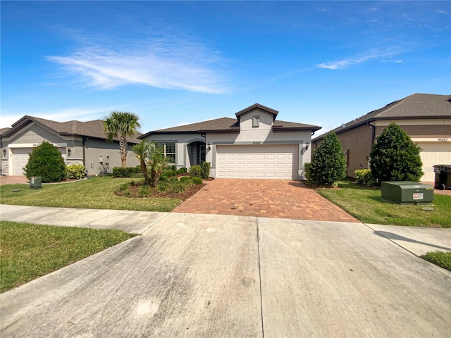 19664 Ship Wheel Way, Land O Lakes, FL 34638 - ranch-style house with stucco siding, decorative driveway, a front lawn, and an attached garage