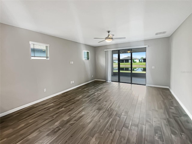 19664 Ship Wheel Way, Land O Lakes, FL 34638 - empty room with dark wood-style flooring, plenty of natural light, and baseboards