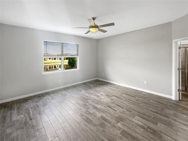 19664 Ship Wheel Way, Land O Lakes, FL 34638 - empty room with dark wood finished floors, a ceiling fan, and baseboards