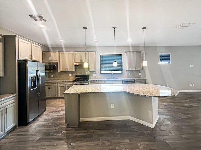 19664 Ship Wheel Way, Land O Lakes, FL 34638 - kitchen featuring appliances with stainless steel finishes, a sink, dark wood finished floors, a kitchen island, and recessed lighting
