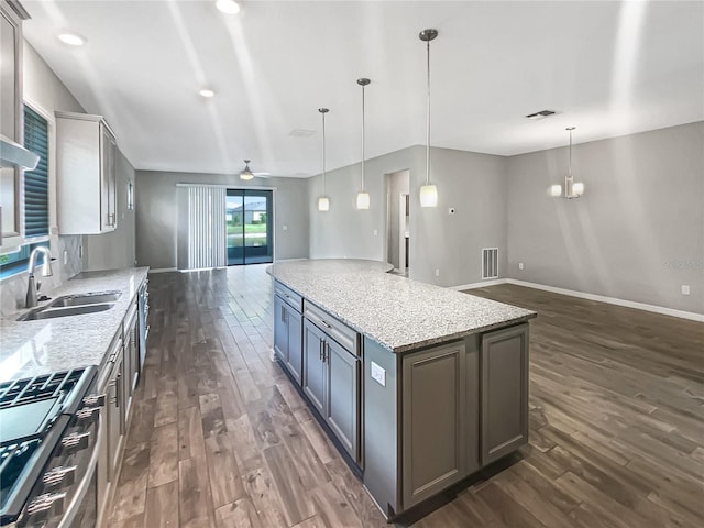 19664 Ship Wheel Way, Land O Lakes, FL 34638 - kitchen featuring a sink, open floor plan, stainless steel gas stove, and dark wood-style flooring