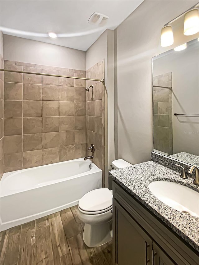 19664 Ship Wheel Way, Land O Lakes, FL 34638 - bathroom with wood finished floors, vanity, toilet, and shower / tub combination