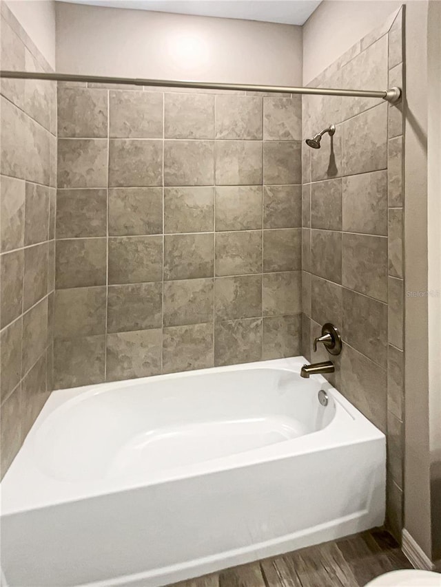 19664 Ship Wheel Way, Land O Lakes, FL 34638 - bathroom featuring wood finished floors, tub / shower combination, and toilet