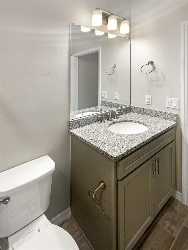19664 Ship Wheel Way, Land O Lakes, FL 34638 - bathroom featuring vanity, toilet, and baseboards