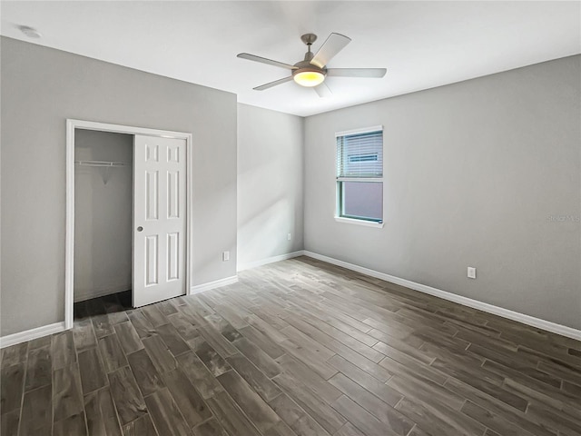 19664 Ship Wheel Way, Land O Lakes, FL 34638 - unfurnished bedroom featuring dark wood-style floors, baseboards, a closet, and a ceiling fan