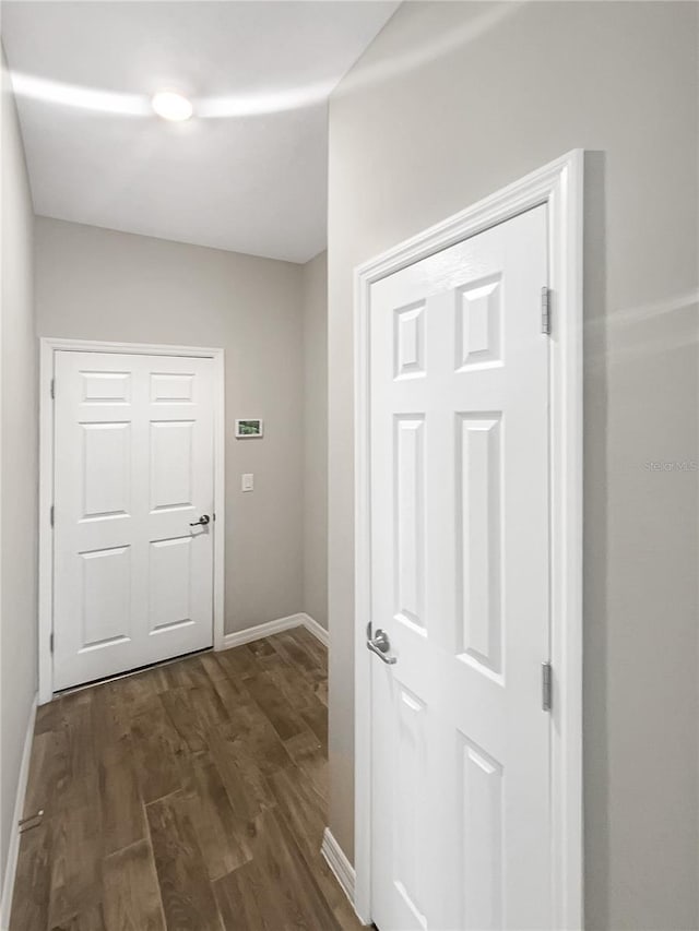 19664 Ship Wheel Way, Land O Lakes, FL 34638 - corridor with dark wood-style floors and baseboards