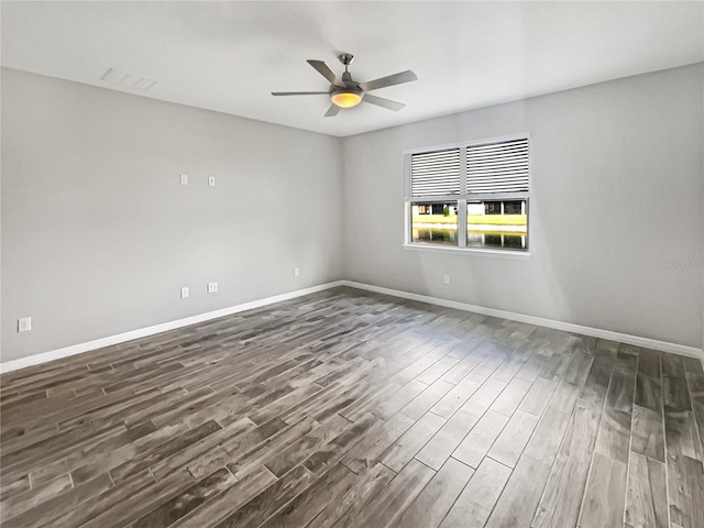 19664 Ship Wheel Way, Land O Lakes, FL 34638 - spare room featuring dark wood-style floors, a ceiling fan, and baseboards