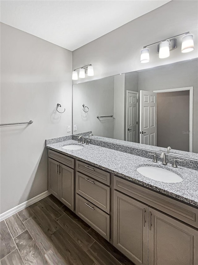 19664 Ship Wheel Way, Land O Lakes, FL 34638 - full bath featuring double vanity, wood finish floors, and baseboards
