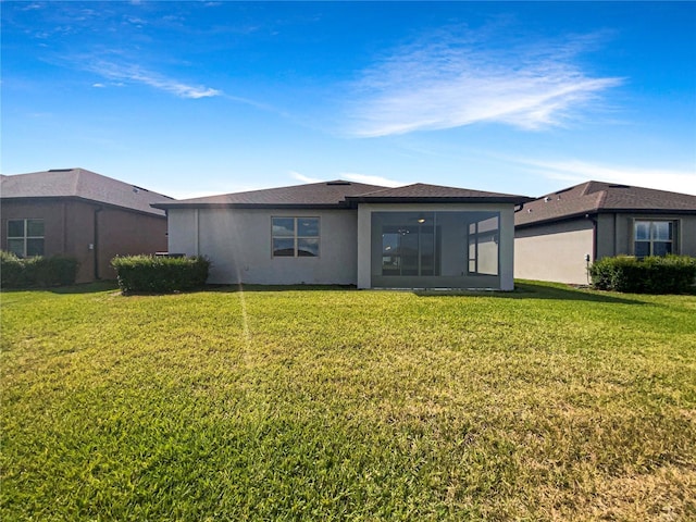 19664 Ship Wheel Way, Land O Lakes, FL 34638 - back of house with a lawn, a sunroom, and stucco siding