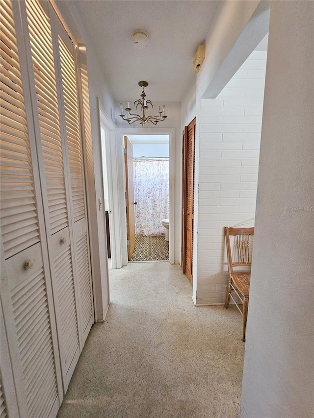 2066 High Ridge Dr, Clearwater, FL 33763 - hall with light colored carpet and a chandelier