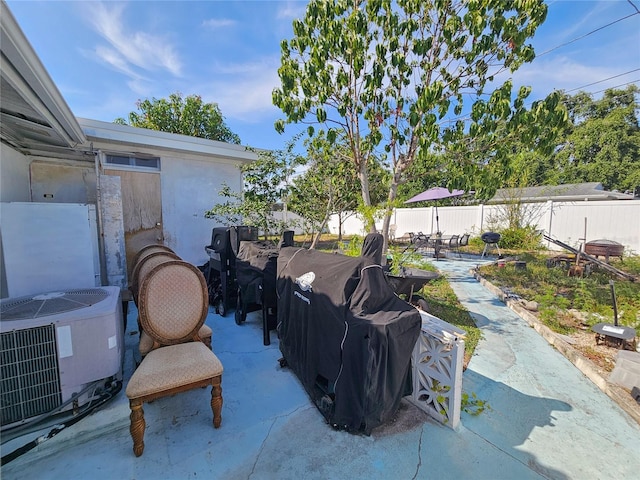 2066 High Ridge Dr, Clearwater, FL 33763 - fenced backyard featuring a patio area, cooling unit, and outdoor dining space