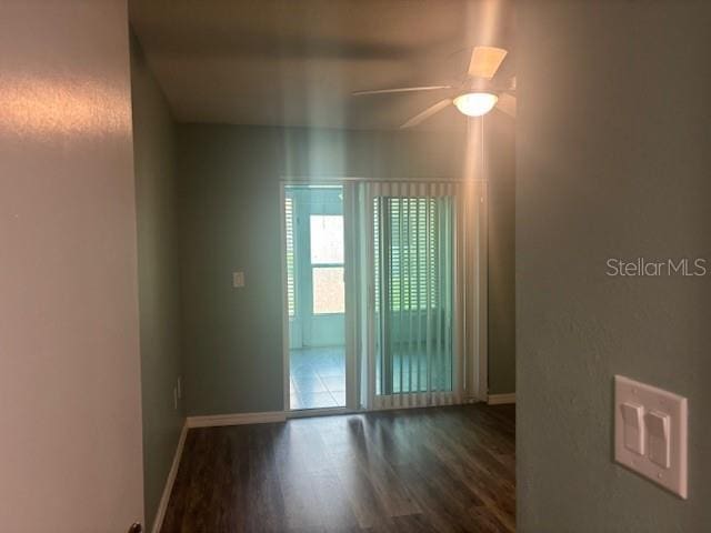 6520 Thicket Trl, New Port Richey, FL 34653 - spare room with wood finished floors, baseboards, and a ceiling fan