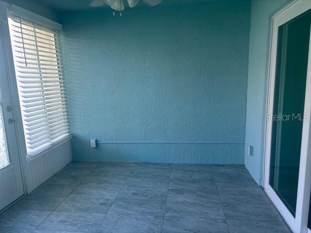 6520 Thicket Trl, New Port Richey, FL 34653 - unfurnished room featuring a ceiling fan and plenty of natural light