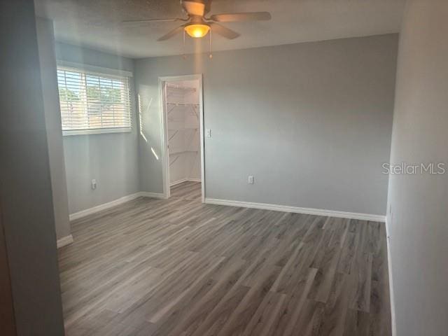 6520 Thicket Trl, New Port Richey, FL 34653 - unfurnished room with a ceiling fan, baseboards, and wood finished floors