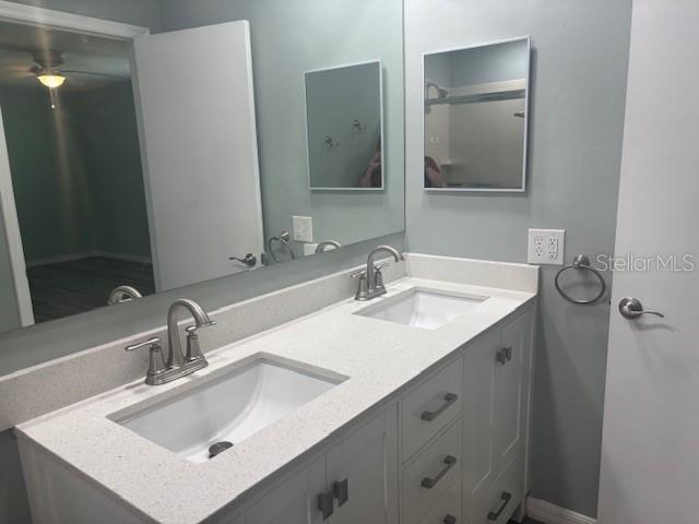 6520 Thicket Trl, New Port Richey, FL 34653 - bathroom featuring double vanity and a ceiling fan