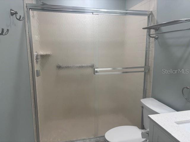 6520 Thicket Trl, New Port Richey, FL 34653 - full bath featuring toilet, a stall shower, and vanity