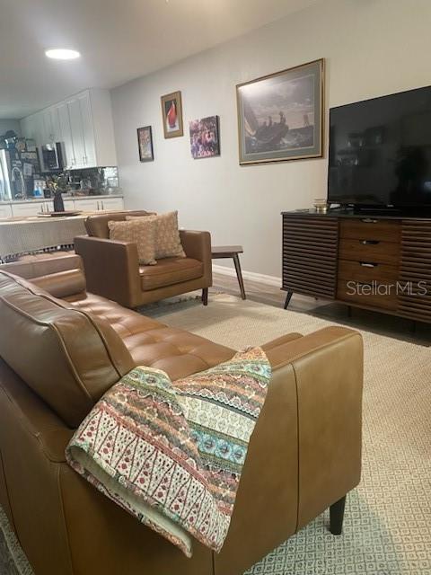 6520 Thicket Trl, New Port Richey, FL 34653 - living area featuring carpet and baseboards