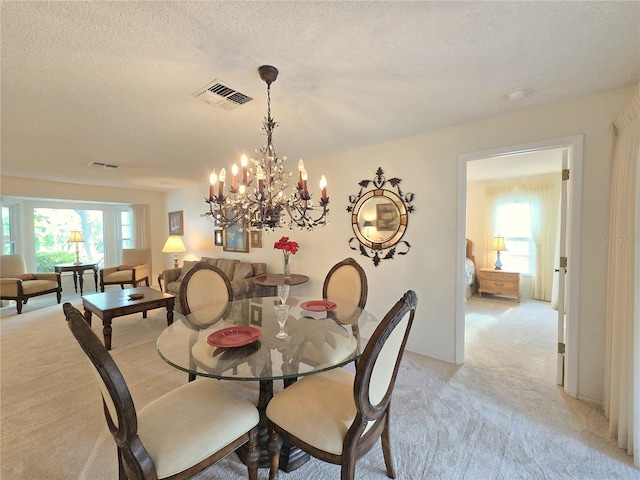 3509 Oak Lake Dr, Palm Harbor, FL 34684 - dining room with light carpet, a chandelier, and a textured ceiling