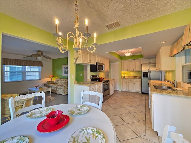 3509 Oak Lake Dr, Palm Harbor, FL 34684 - kitchen with stainless steel appliances, a sink, light tile patterned floors, ceiling fan, and light stone countertops