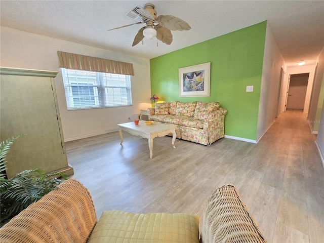 3509 Oak Lake Dr, Palm Harbor, FL 34684 - living area with ceiling fan, light wood finished floors, and baseboards