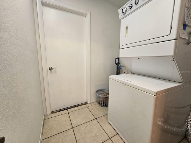3509 Oak Lake Dr, Palm Harbor, FL 34684 - laundry room with stacked washer / dryer and light tile patterned flooring