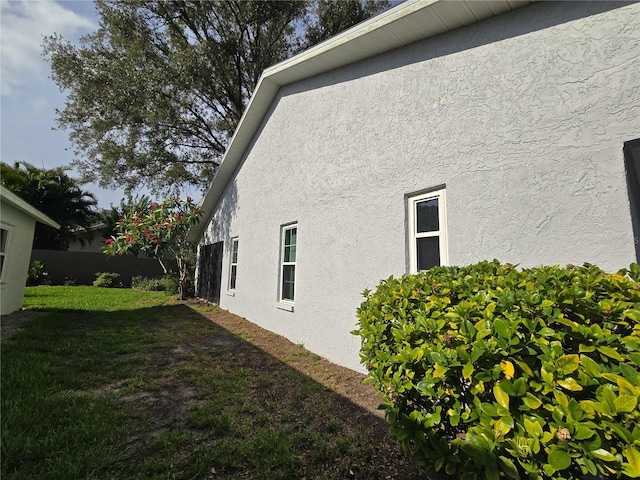 3509 Oak Lake Dr, Palm Harbor, FL 34684 - view of side of property featuring stucco siding and a yard