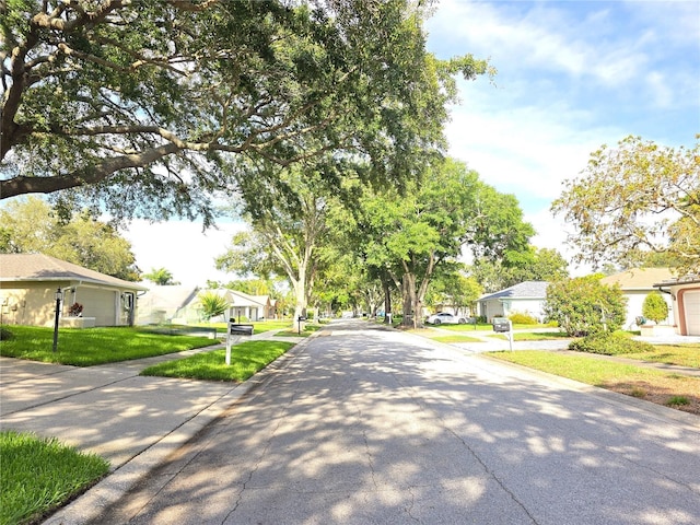 3509 Oak Lake Dr, Palm Harbor, FL 34684 - view of asphalt street featuring a residential view, sidewalks, and curbs