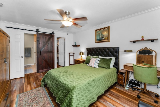 704 Lyndhurst St Unit 624, Dunedin, FL 34698 - bedroom with a barn door, hardwood / wood-style floors, ornamental molding, ceiling fan, and a closet