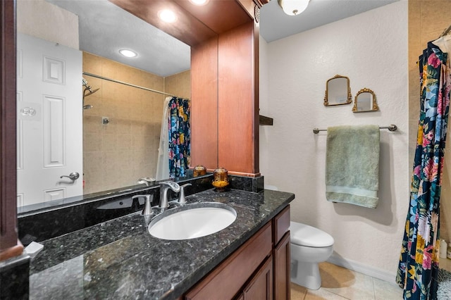 704 Lyndhurst St Unit 624, Dunedin, FL 34698 - bathroom featuring vanity, toilet, baseboards, tile patterned flooring, and curtained shower