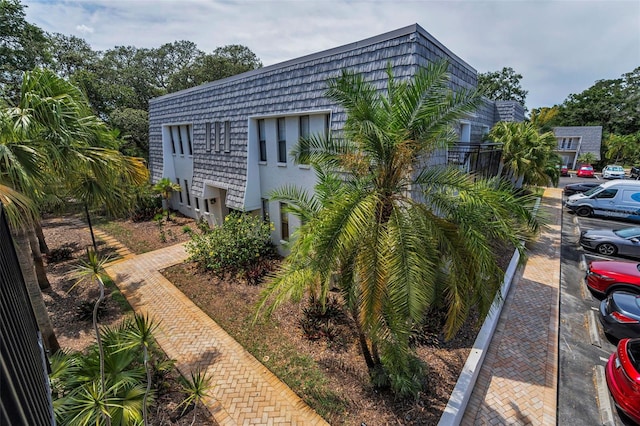 704 Lyndhurst St Unit 624, Dunedin, FL 34698 - view of side of property with uncovered parking and mansard roof