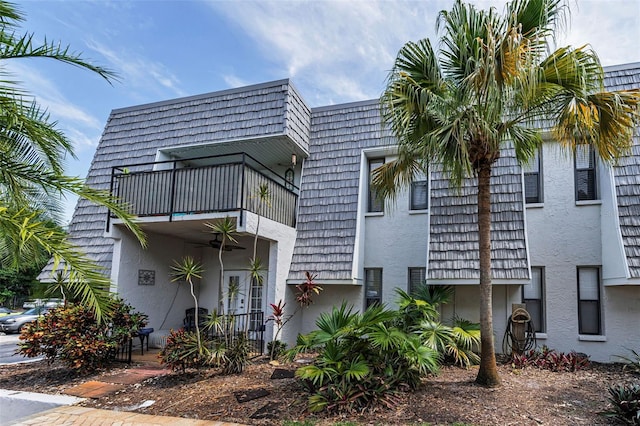 704 Lyndhurst St Unit 624, Dunedin, FL 34698 - exterior space with a balcony, mansard roof, and stucco siding