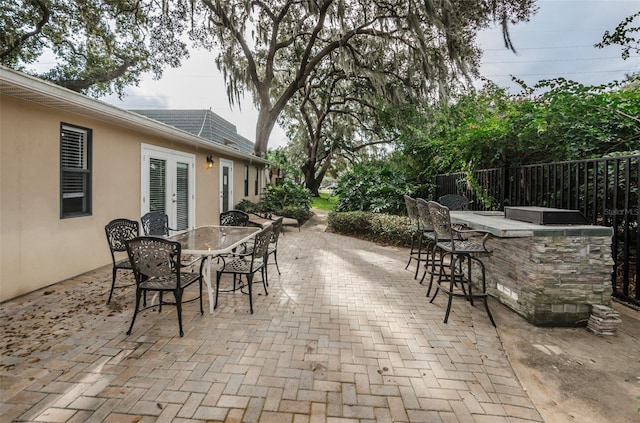 704 Lyndhurst St Unit 624, Dunedin, FL 34698 - view of patio with french doors and outdoor dining area