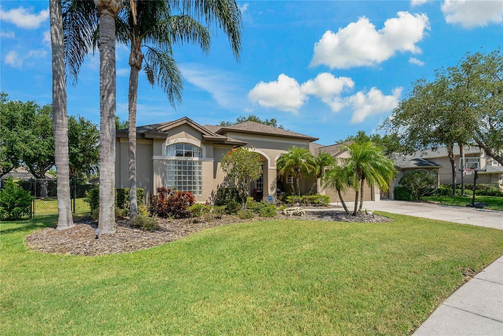 4530 Roanoak Way, Palm Harbor, FL 34685 - mediterranean / spanish-style house featuring concrete driveway, stucco siding, and an attached garage