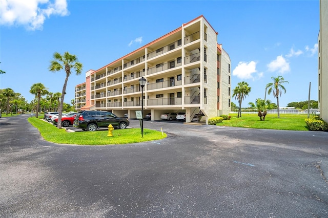 9450 Harbor Greens Way Unit 207, Seminole, FL 33776 - view of apartment building / complex with covered and uncovered parking